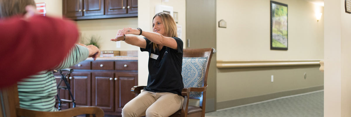 Pavilion staff member showing physical therapy exercises