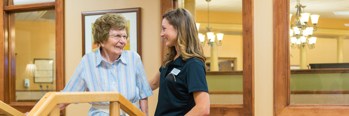Pavilion caregiver assists resident with rehabilitation