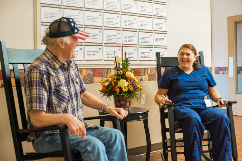 Resident and caregiver in rocking chairs